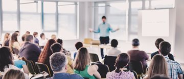 Spring Conference Speakers Giving a Talk at Business Meeting. Audience in the conference hall. Business and Entrepreneurship concept.